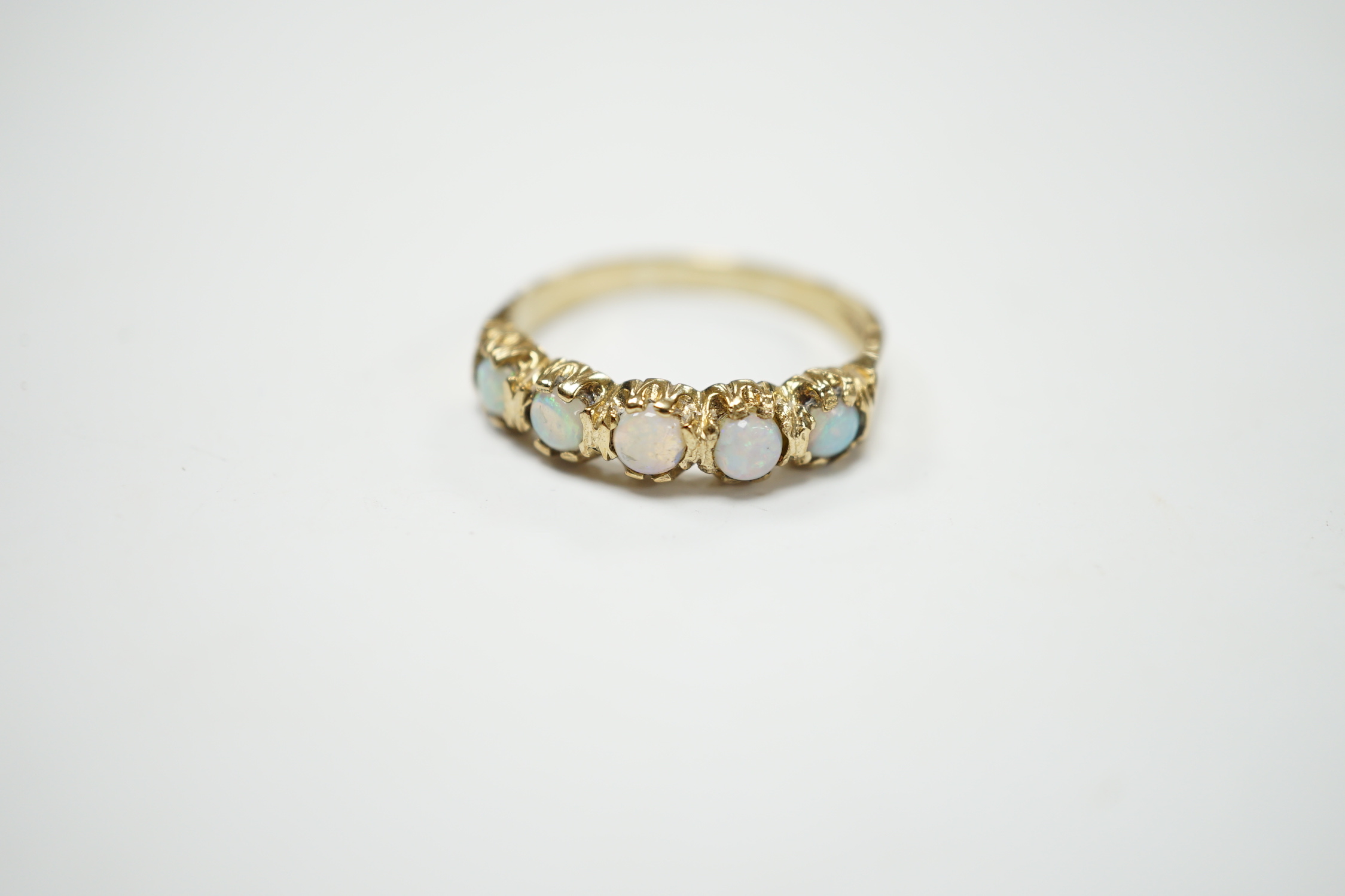 A modern 9ct gold and five stone white opal set half hoop ring, size T/U, gross weight 2.9 grams.